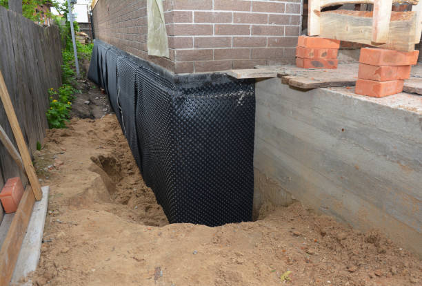 SJ Waterproofing Pros technician performing targeted Wet Basement Repair assessment in Middleburg, OH